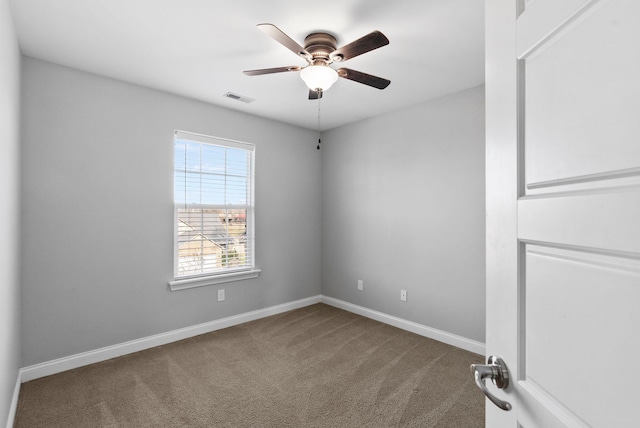 carpeted empty room featuring visible vents, ceiling fan, and baseboards