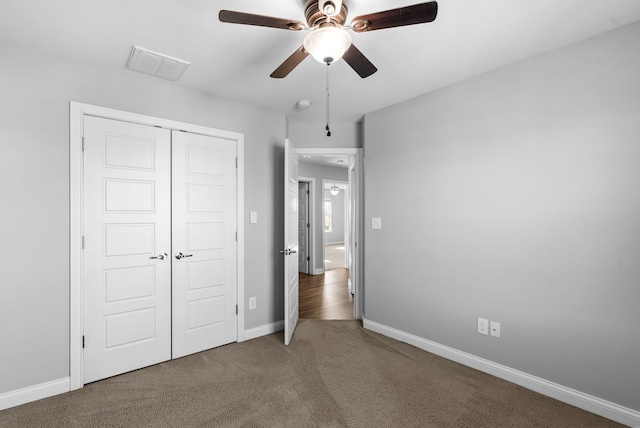 unfurnished bedroom with visible vents, a ceiling fan, a closet, carpet floors, and baseboards