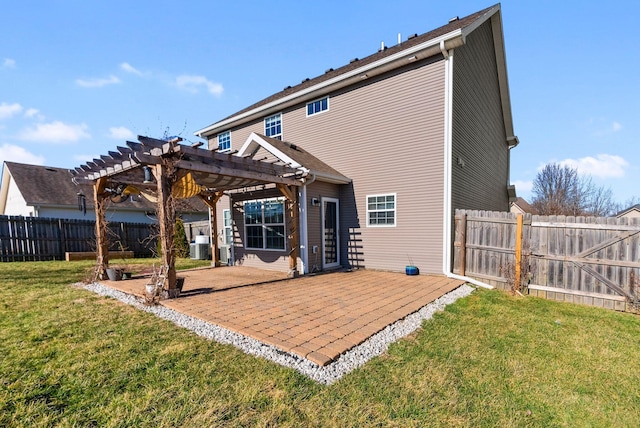 rear view of house with a lawn, a fenced backyard, a pergola, and a patio area