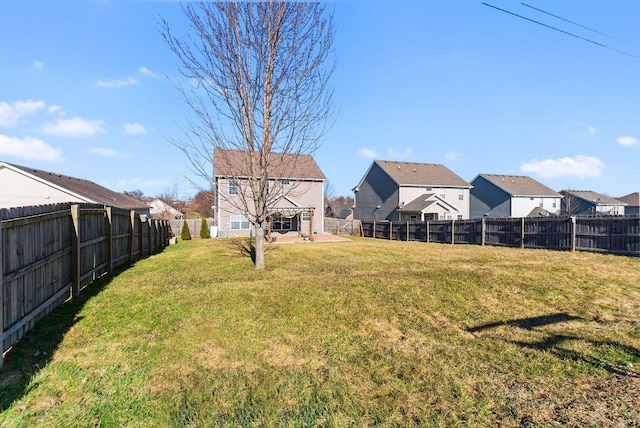 view of yard with a residential view and a fenced backyard