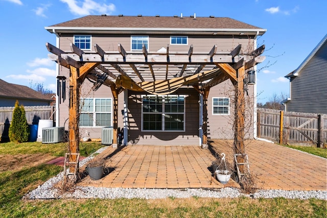 rear view of property featuring central air condition unit, fence, and a pergola