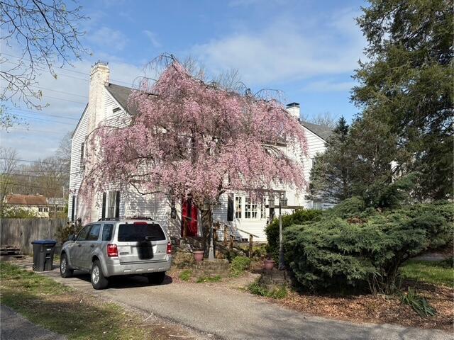 108 Linden Ave, Frankfort, KY 40601 - view of property hidden behind natural elements featuring driveway, a chimney, and fence