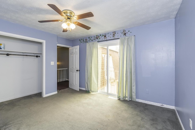 unfurnished bedroom with baseboards, ceiling fan, a closet, a textured ceiling, and carpet flooring