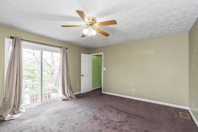 empty room with visible vents, baseboards, ceiling fan, and carpet floors