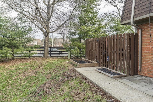 view of yard featuring a garden and fence