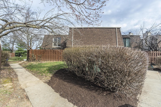 view of side of property featuring fence