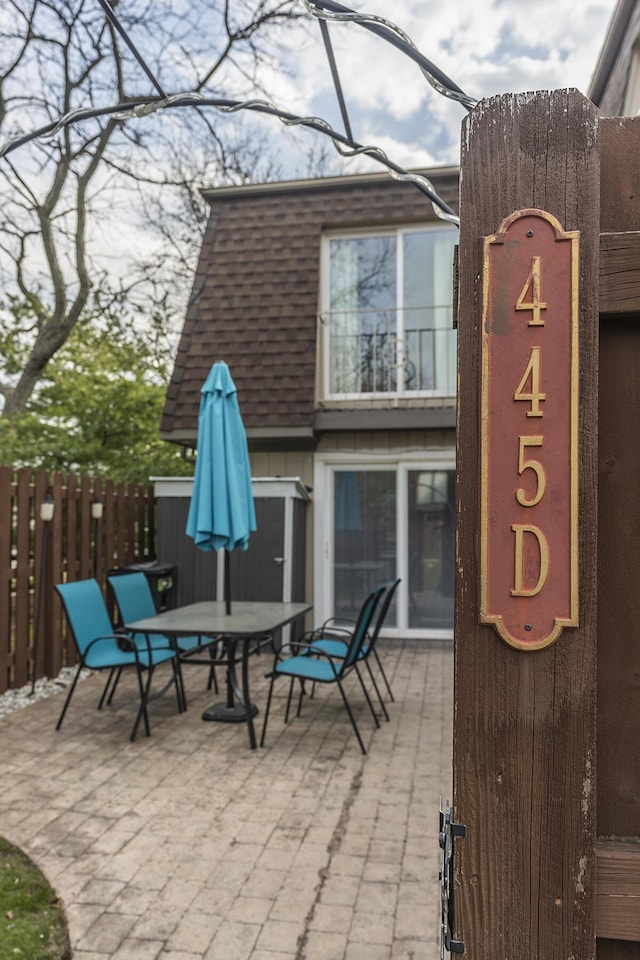 view of patio with outdoor dining area and fence