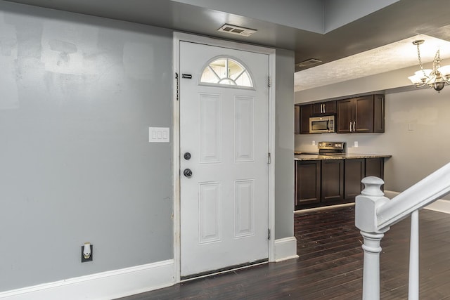 foyer featuring visible vents, baseboards, and dark wood-style floors