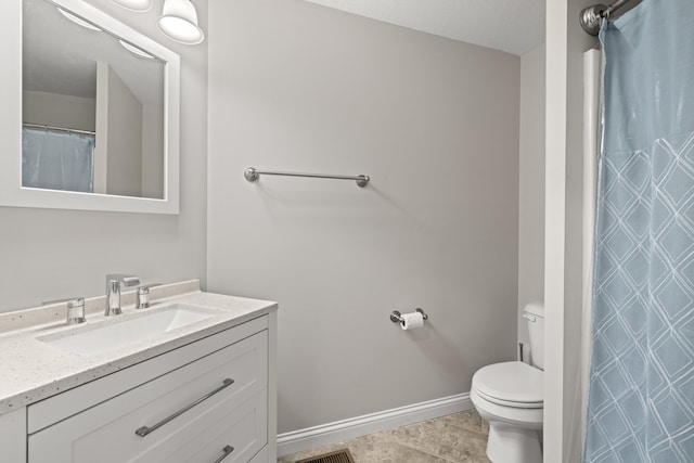 bathroom featuring tile patterned floors, toilet, vanity, and baseboards