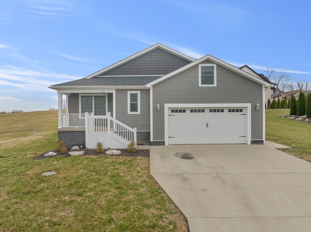 view of front of property with an attached garage, concrete driveway, and a front lawn