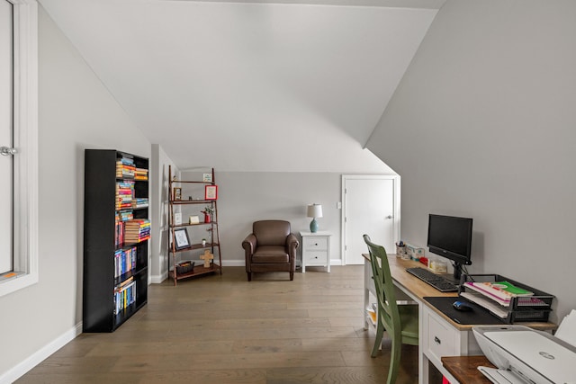 office area featuring vaulted ceiling, baseboards, and wood finished floors