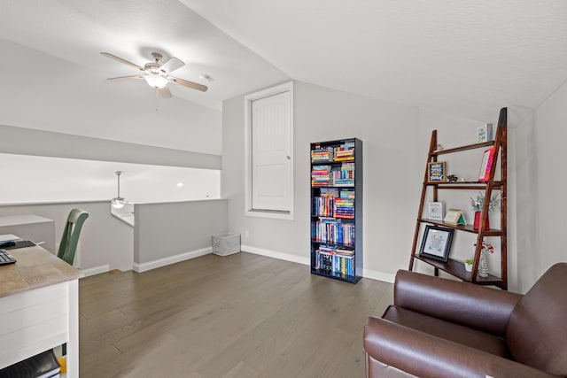 home office featuring vaulted ceiling, baseboards, a ceiling fan, and wood finished floors