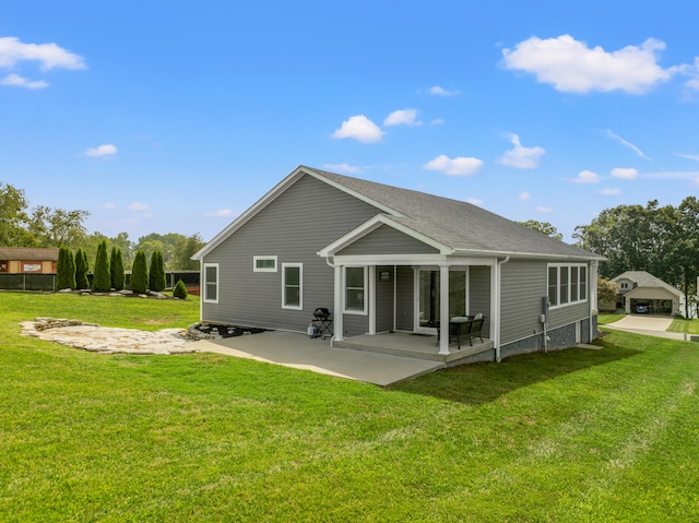 back of property featuring a patio area and a lawn