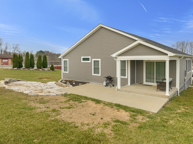 back of property featuring a patio and a yard