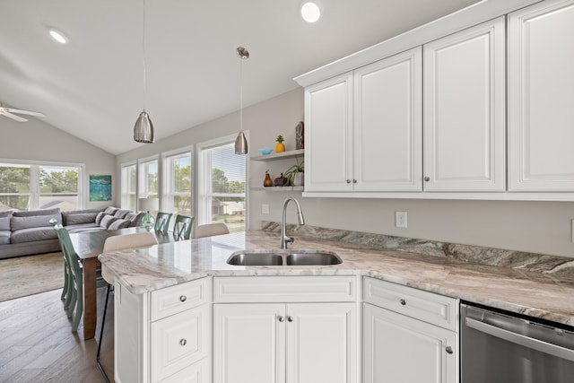 kitchen with a sink, open floor plan, dishwasher, white cabinets, and open shelves