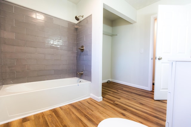 full bathroom with baseboards, shower / tub combination, and wood finished floors