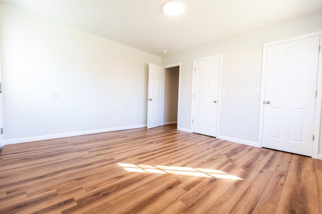 unfurnished bedroom featuring baseboards and light wood finished floors