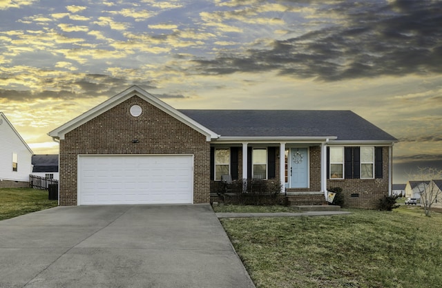 single story home featuring a garage, a yard, concrete driveway, crawl space, and brick siding