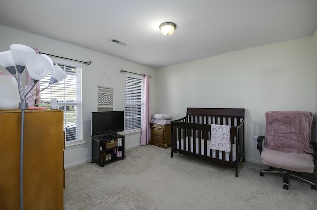 carpeted bedroom featuring visible vents and baseboards