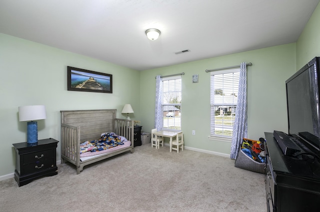 carpeted bedroom featuring baseboards and visible vents