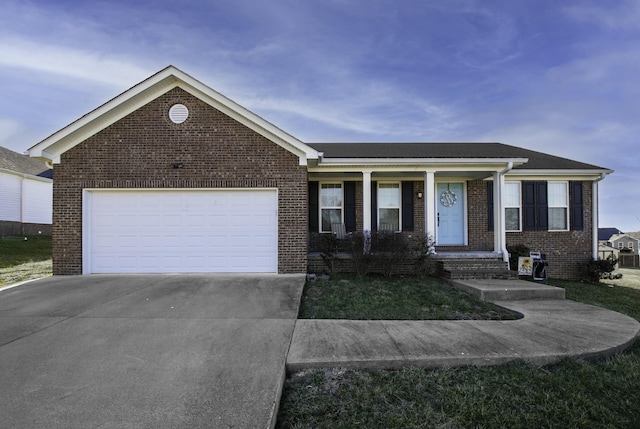 ranch-style house with covered porch, brick siding, a garage, and driveway