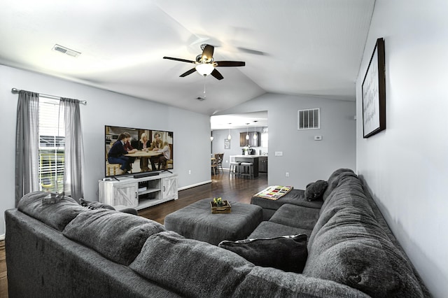 living area with visible vents, lofted ceiling, dark wood finished floors, and a ceiling fan