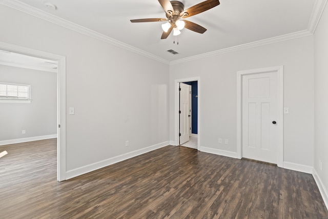 spare room featuring baseboards, dark wood-style flooring, and crown molding