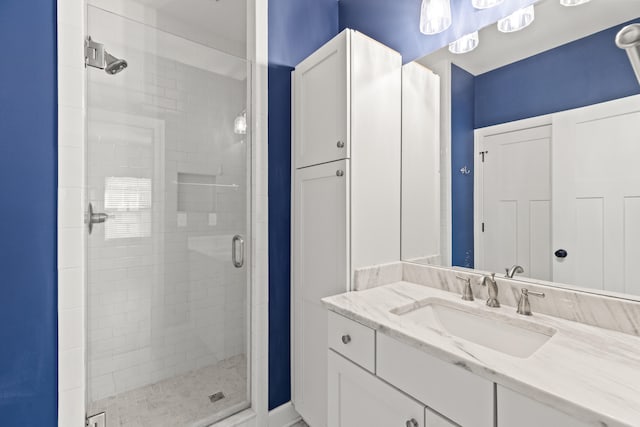 bathroom with vanity and a shower stall