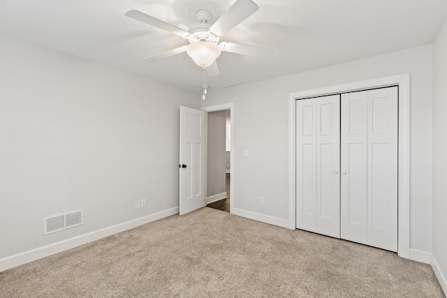 unfurnished bedroom with visible vents, baseboards, carpet, and a closet