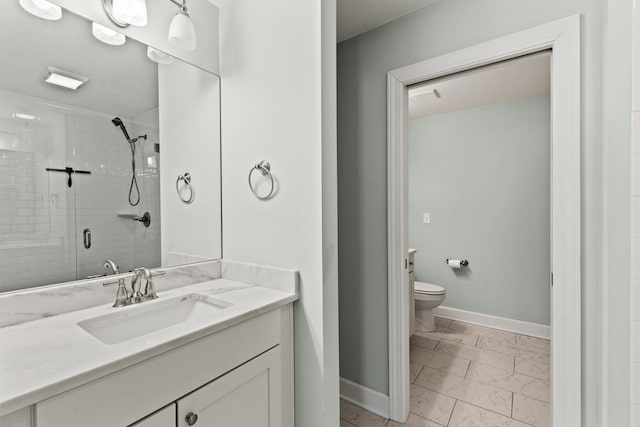 bathroom featuring baseboards, toilet, a stall shower, marble finish floor, and vanity