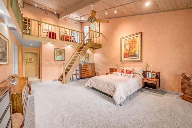 bedroom with rail lighting, visible vents, wooden ceiling, and carpet flooring