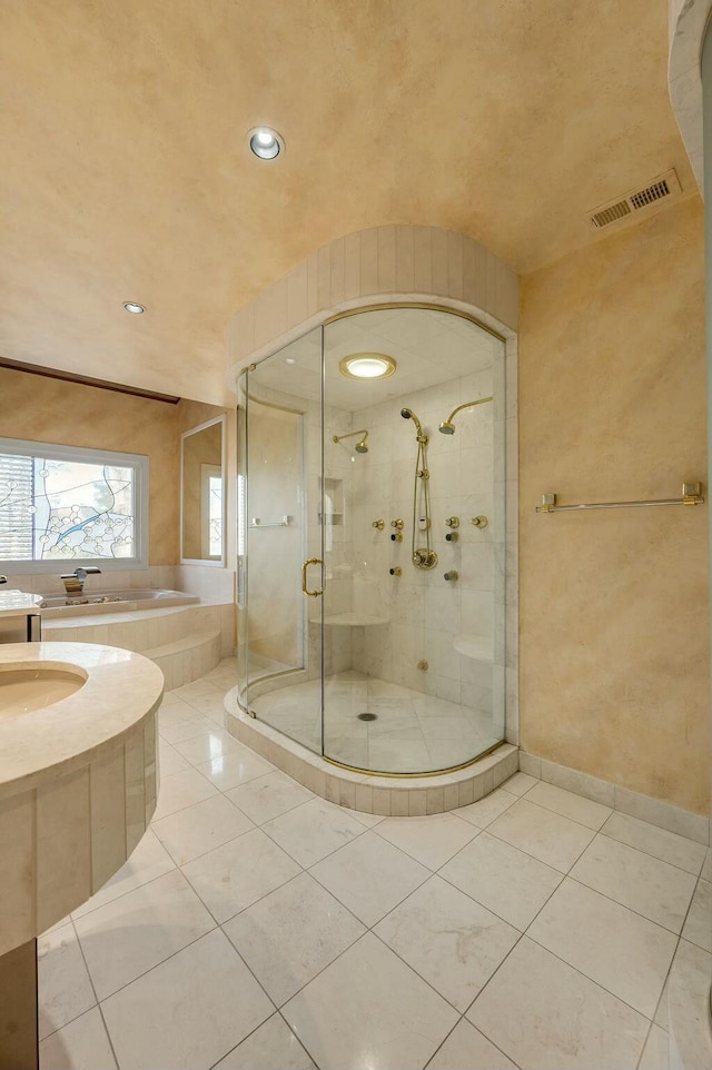 bathroom with tile patterned flooring, a garden tub, visible vents, and a stall shower