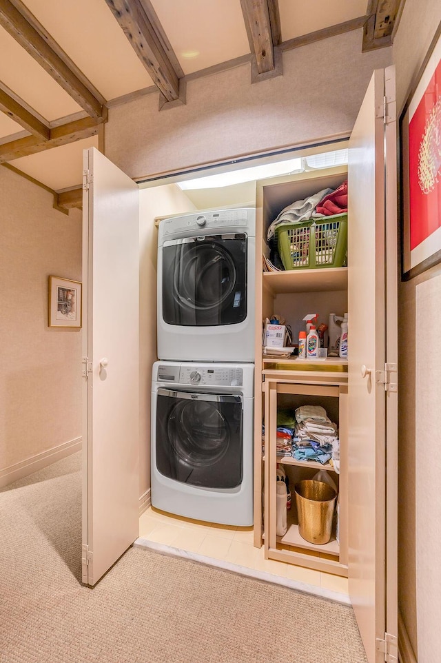 laundry room featuring laundry area, stacked washer / drying machine, and carpet floors