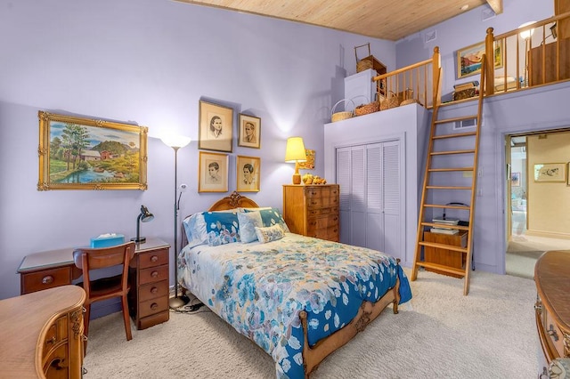 carpeted bedroom featuring a closet and wood ceiling