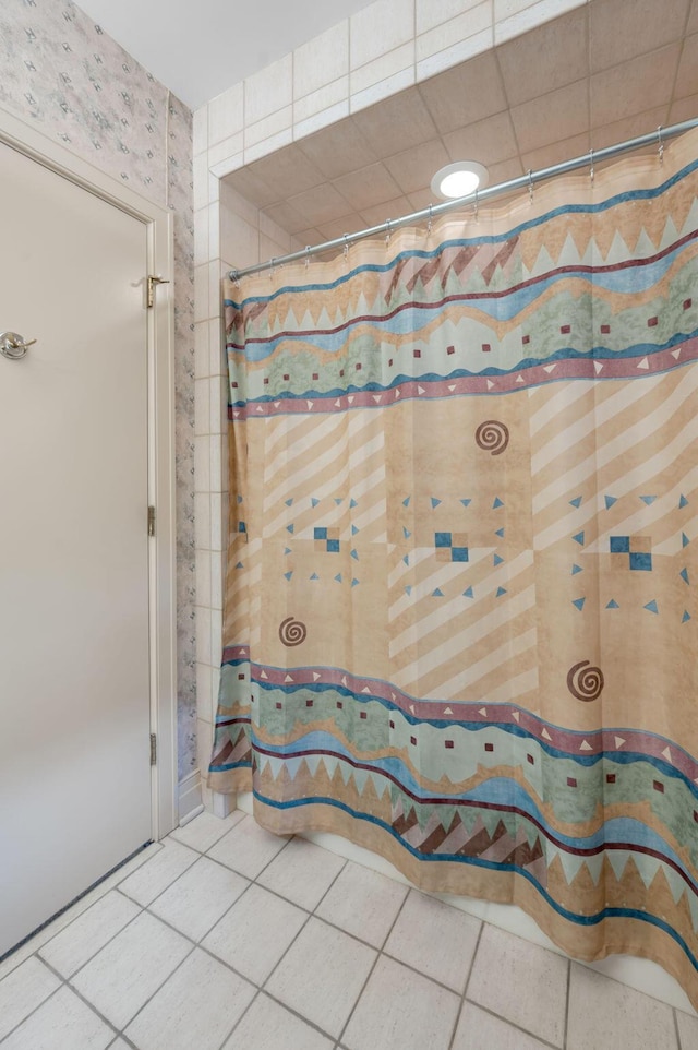 bathroom with a shower with curtain and tile patterned flooring