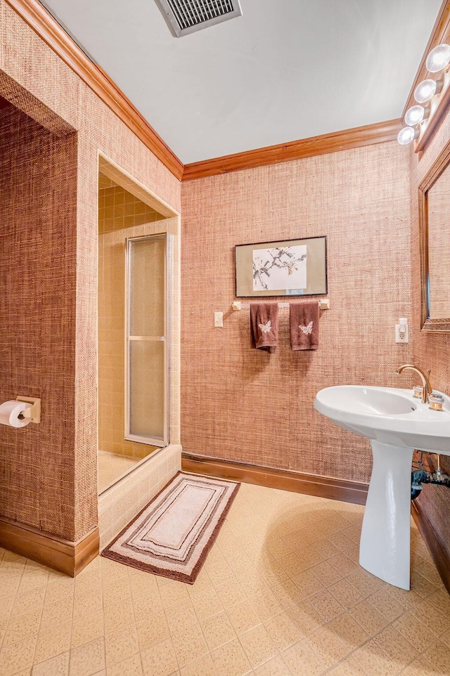 bathroom with visible vents, a stall shower, wallpapered walls, and crown molding