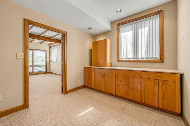 empty room with visible vents, beam ceiling, recessed lighting, baseboards, and light colored carpet