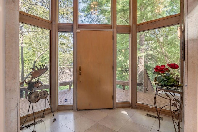 doorway to outside featuring tile patterned floors and visible vents