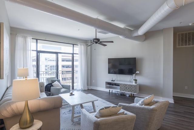 living room with ceiling fan, visible vents, baseboards, and wood finished floors