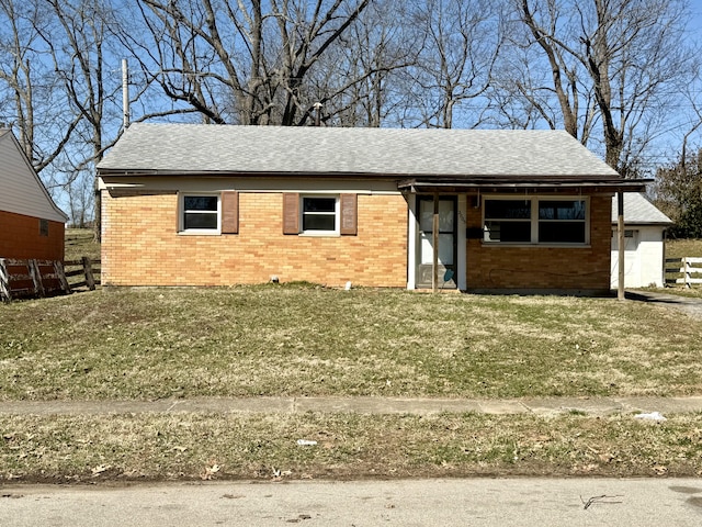 ranch-style house with brick siding, a front lawn, and fence