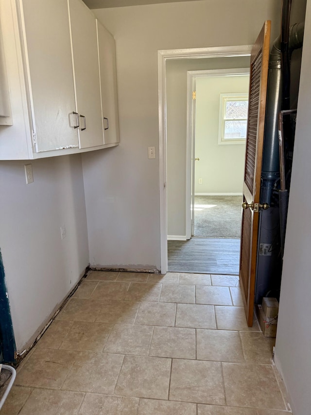 laundry room with baseboards