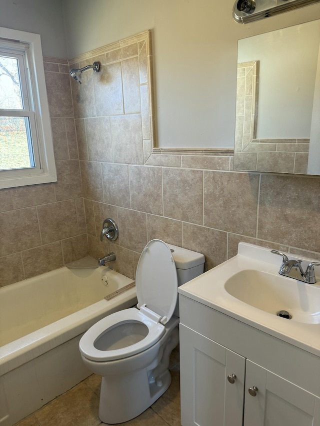 full bath with toilet, tile walls, shower / washtub combination, and vanity