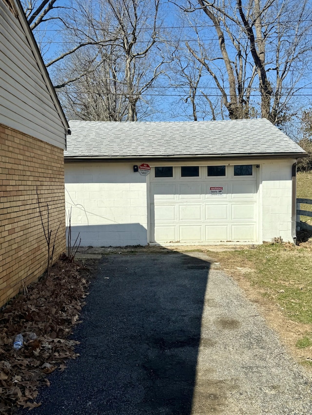 garage featuring aphalt driveway