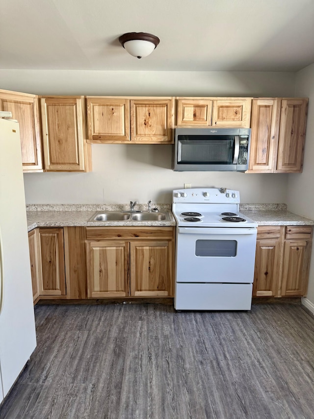 kitchen featuring dark wood-style floors, white appliances, light countertops, and a sink