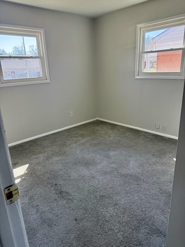 empty room with baseboards and carpet floors