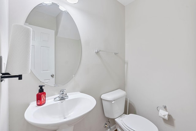 bathroom with toilet and a sink