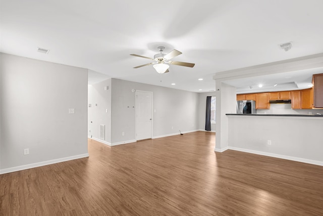 unfurnished living room featuring visible vents, baseboards, ceiling fan, recessed lighting, and wood finished floors