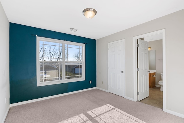 unfurnished bedroom featuring visible vents, baseboards, and carpet floors