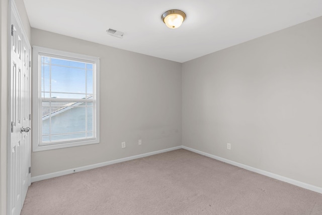 unfurnished room featuring visible vents, baseboards, and carpet