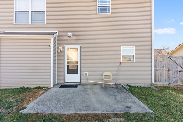 rear view of house with a patio and fence